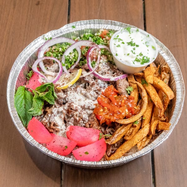 Liberty’s Mediterranean Giant Grinders' shawarma bowl with meat, fries, pickled turnips, tabbouleh, and sauces.